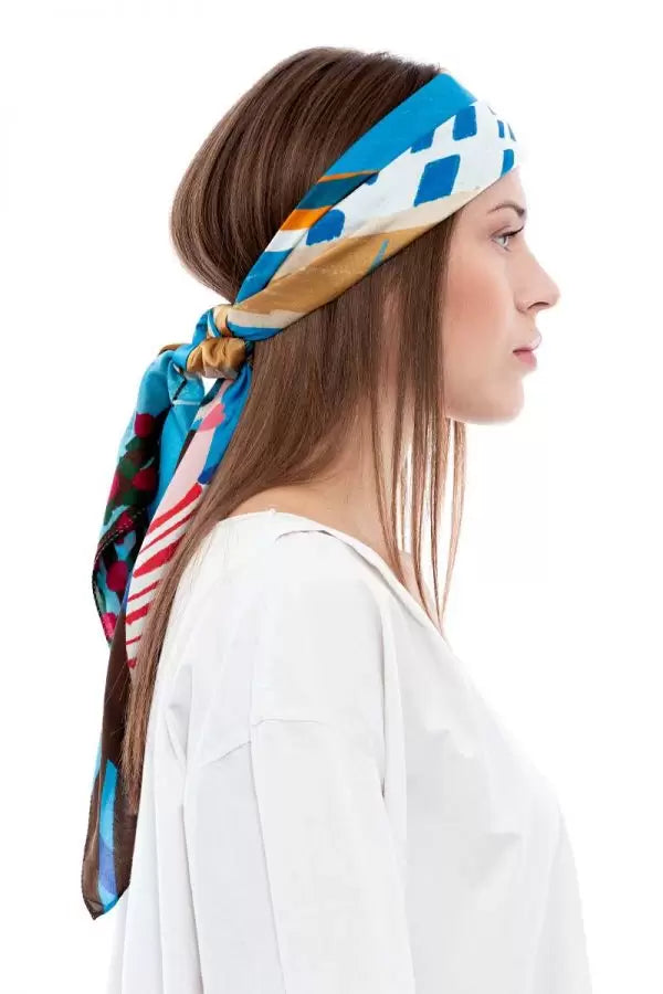 Woman wearing a colorful headscarf with a white background