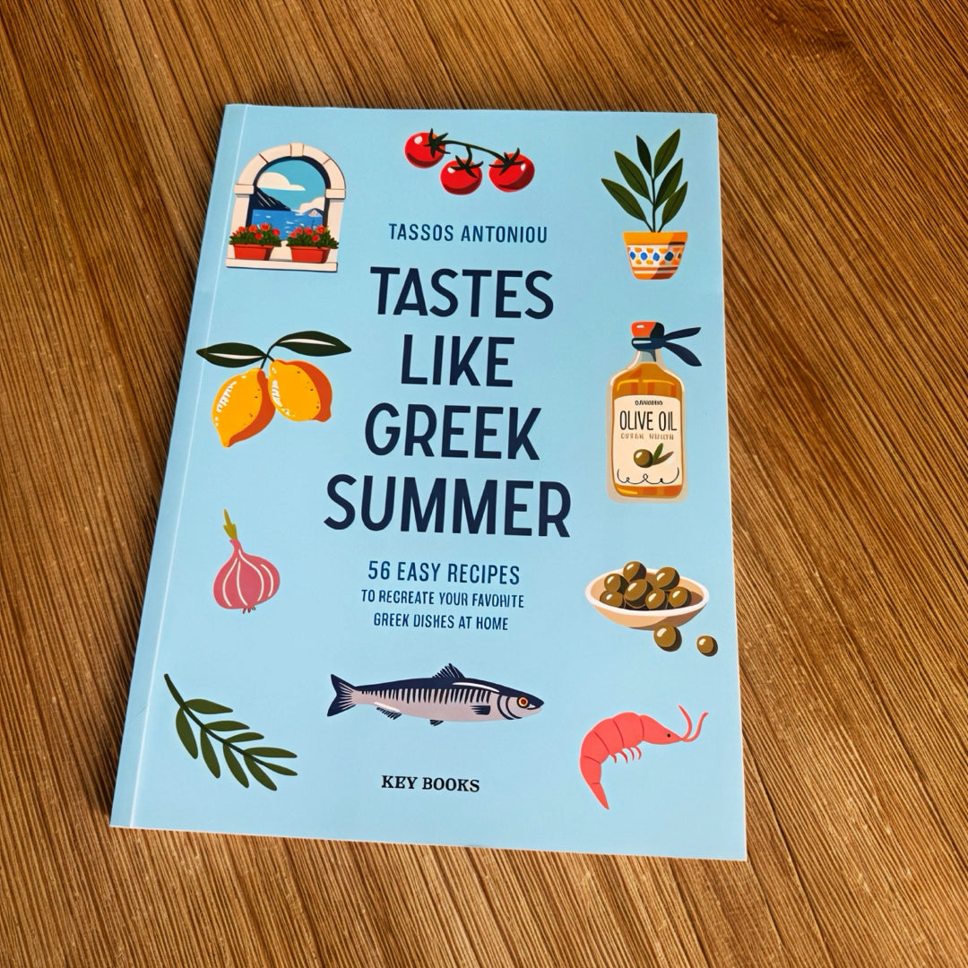 Book titled 'Tastes Like Greek Summer' on a wooden surface