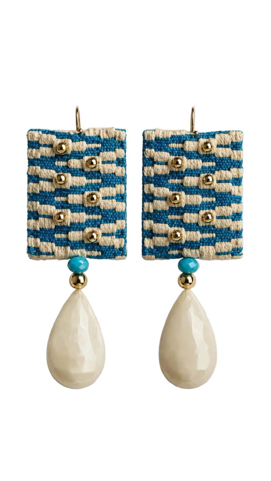 A pair of bohemian-style drop earrings featuring rectangular woven blue and cream fabric panels with gold-tone studs, a small turquoise bead, and a large cream teardrop bead dangling below.