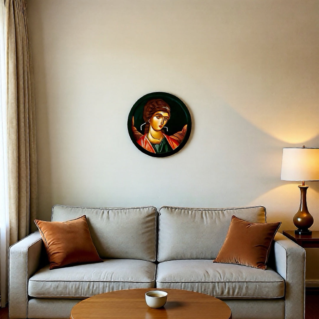 Living room with a beige sofa, round table, and wall art of a religious icon.