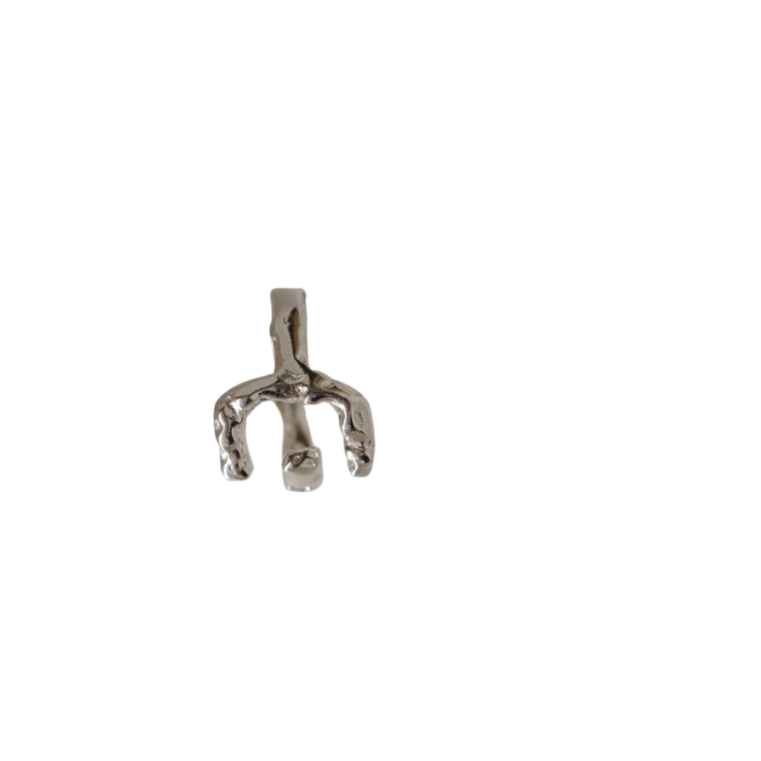 Small silver horse figurine casting a shadow on a light-colored surface