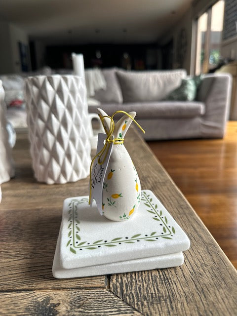 Decorative bunny with a bow on a wooden surface