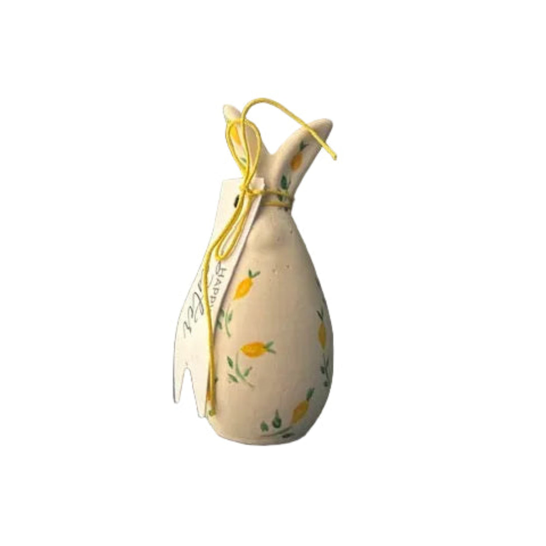 Decorative ceramic item shaped like a bunny with carrot designs on a white background