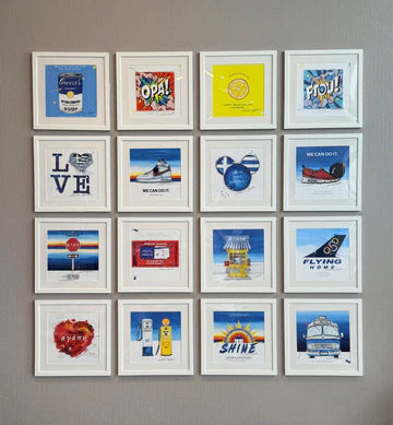 Grid of framed pictures on a wall with various designs and text.