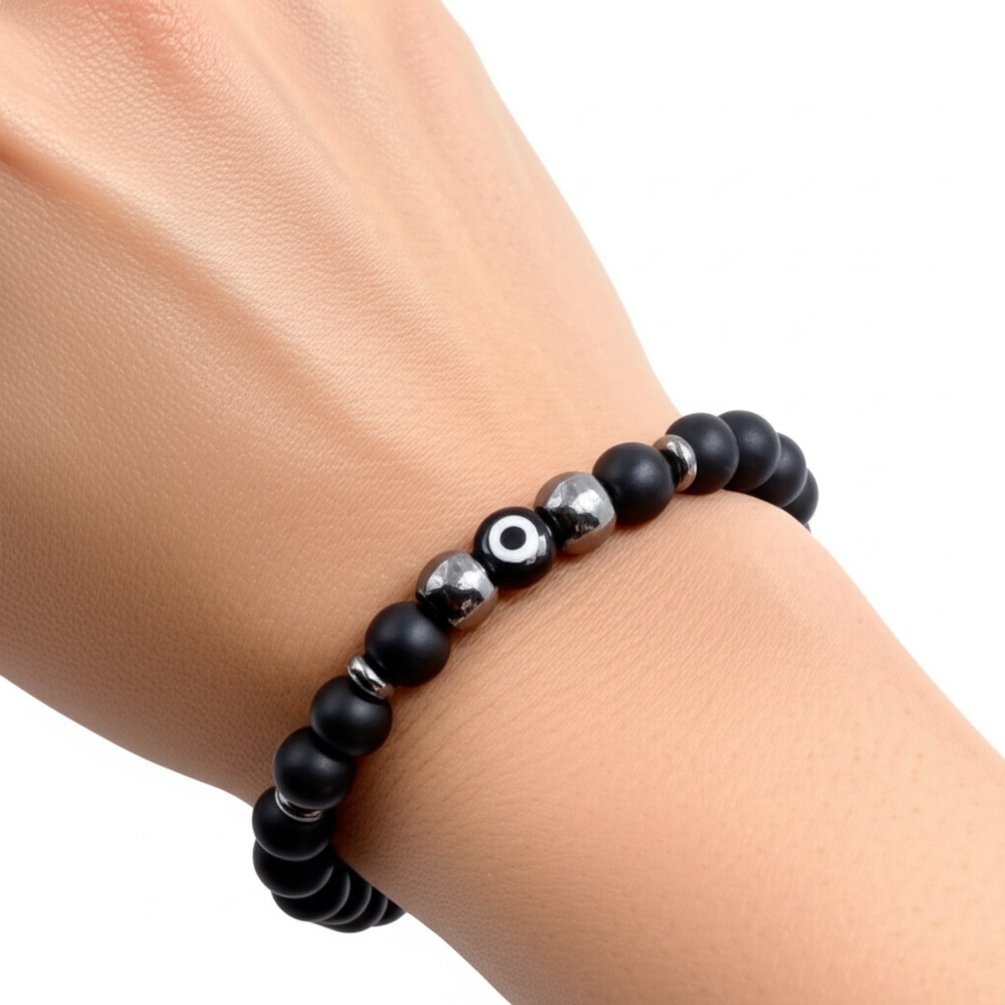 Black beaded bracelet with silver accents on a wrist against a white background