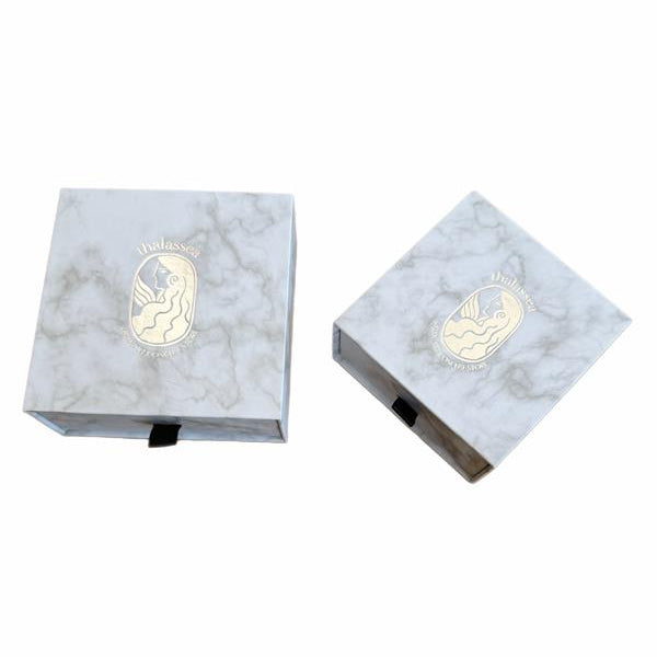 Two marble-textured boxes with a logo on a white background