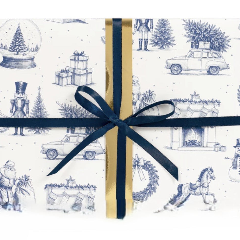 Gift wrapped in festive paper with blue ribbon on a white background