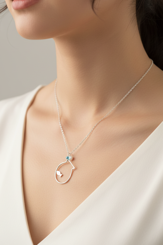 Necklace with a pendant worn by a model against a neutral background