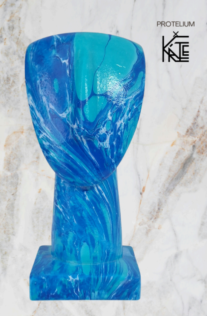 Blue and green marbled vase on a marble background with 'Protelium' branding.