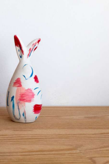 Decorative ceramic bunny with colorful design on a wooden surface