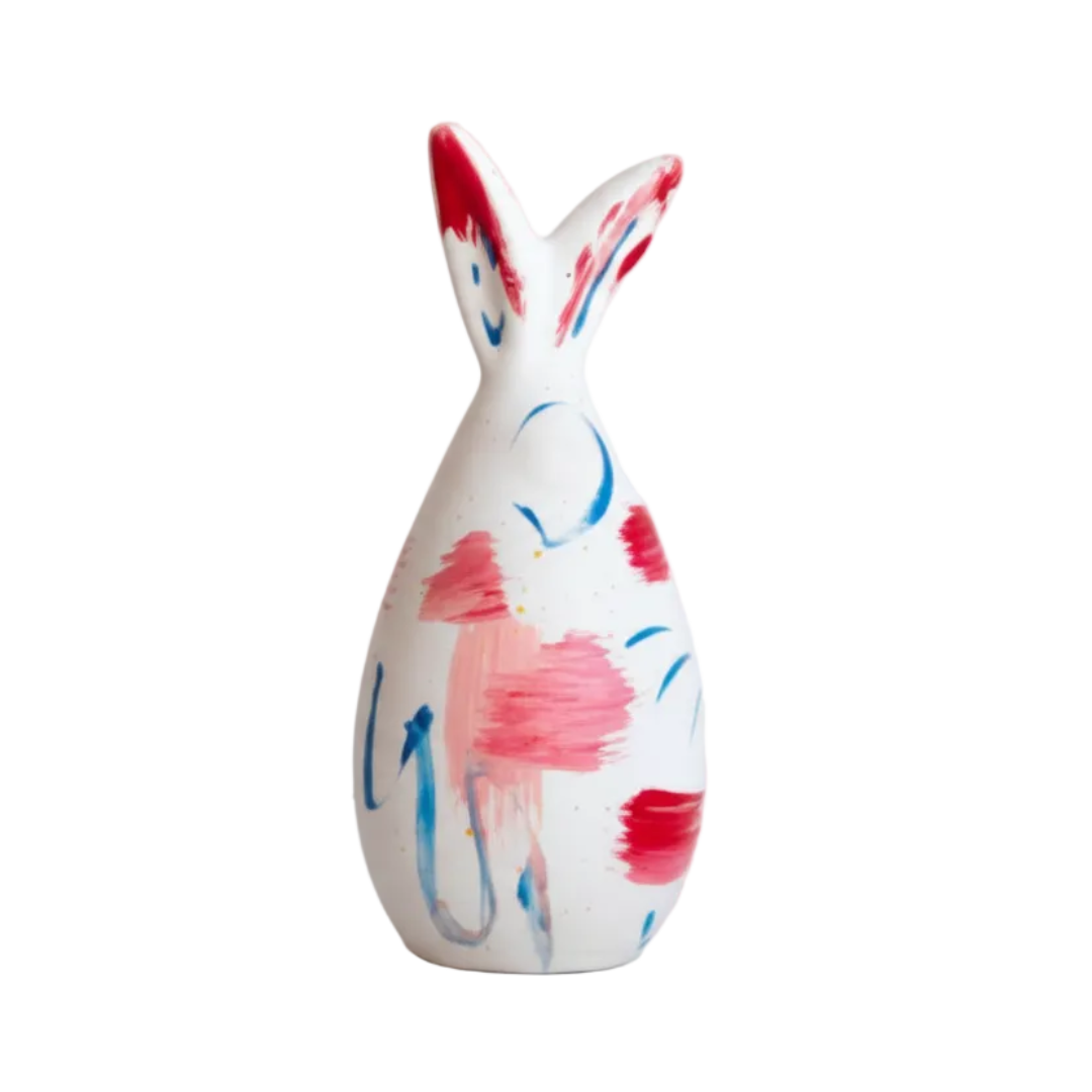 Decorative ceramic bunny with pink and blue abstract patterns on a white background