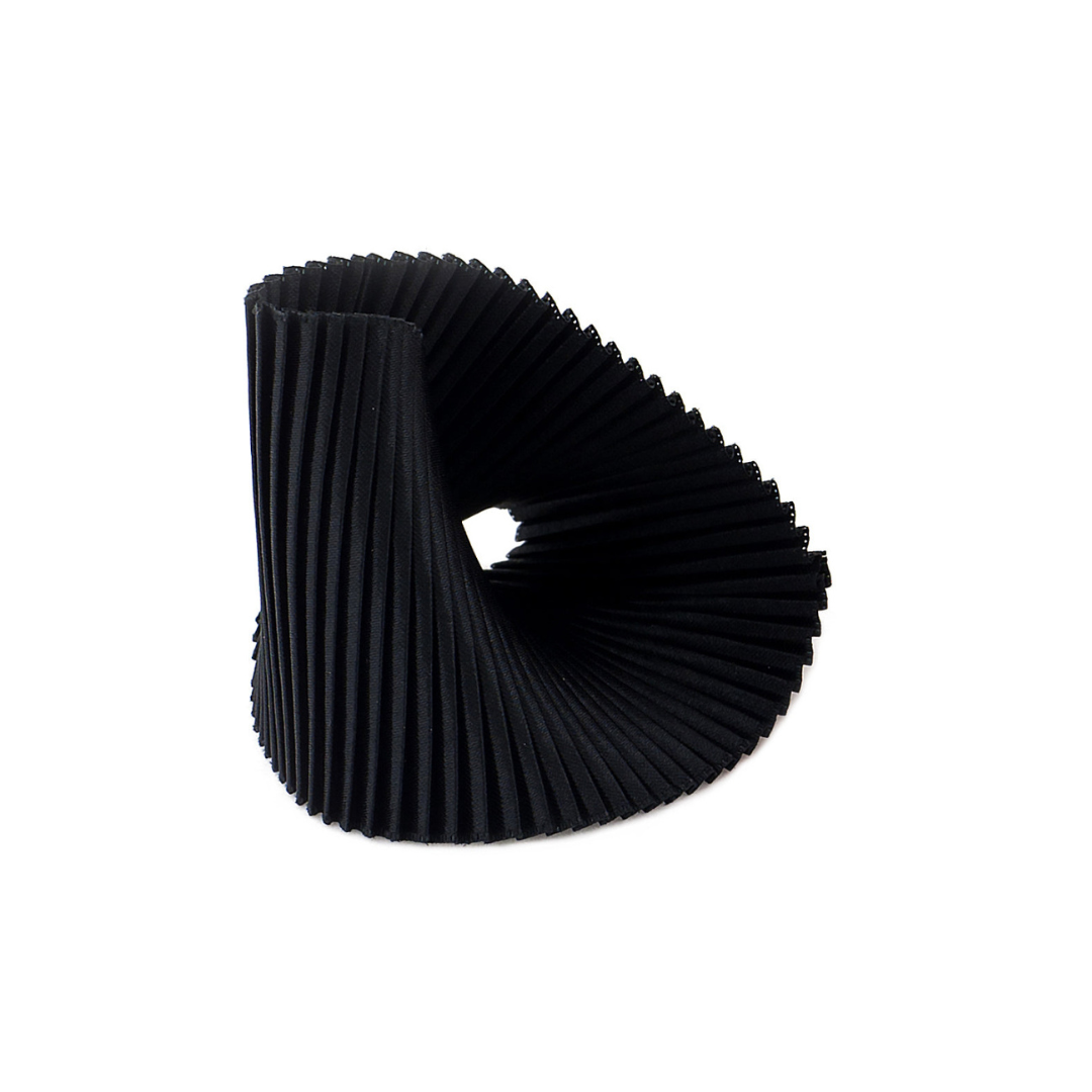 Black pleated object on a white background