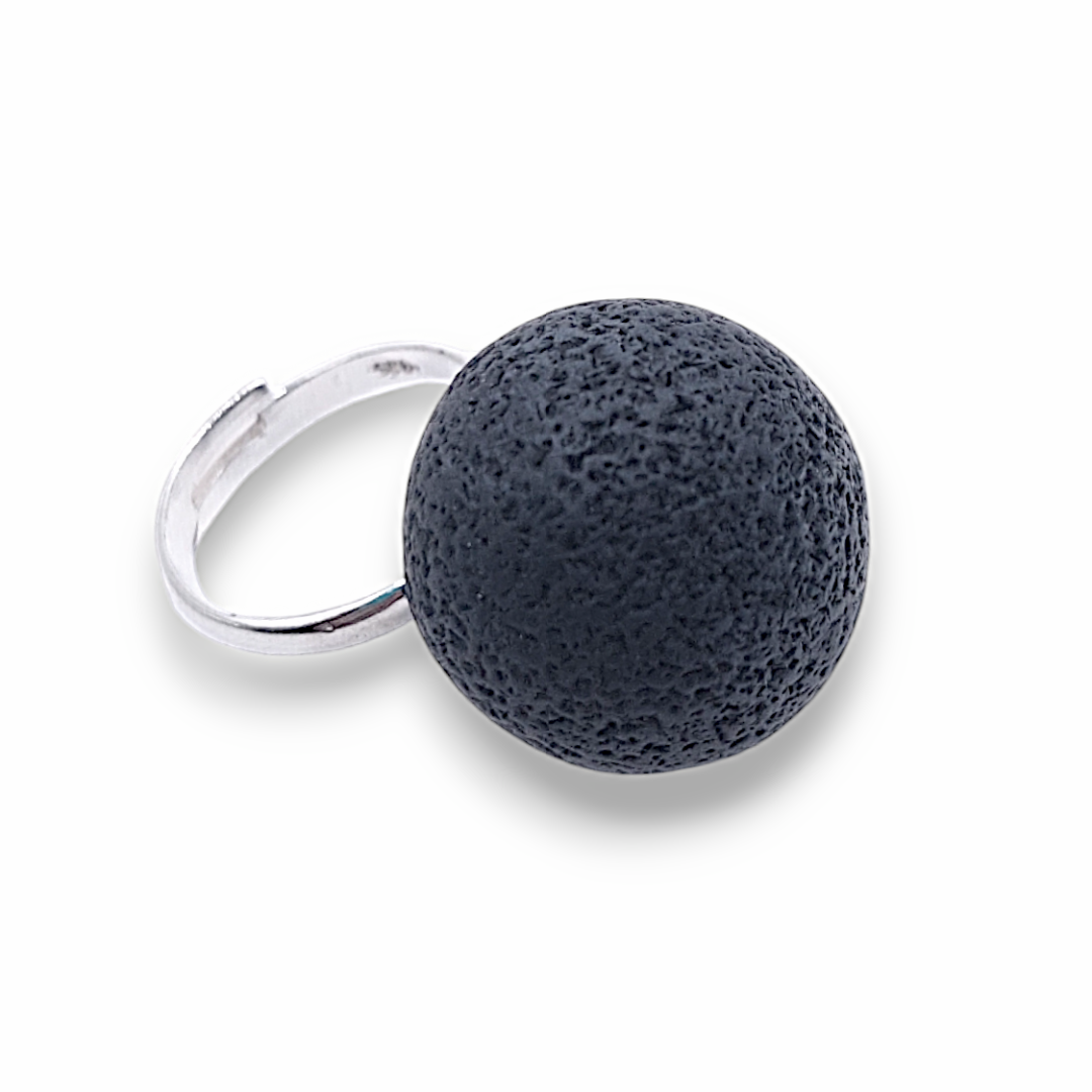 Ring with a dark blue textured ball on a white background