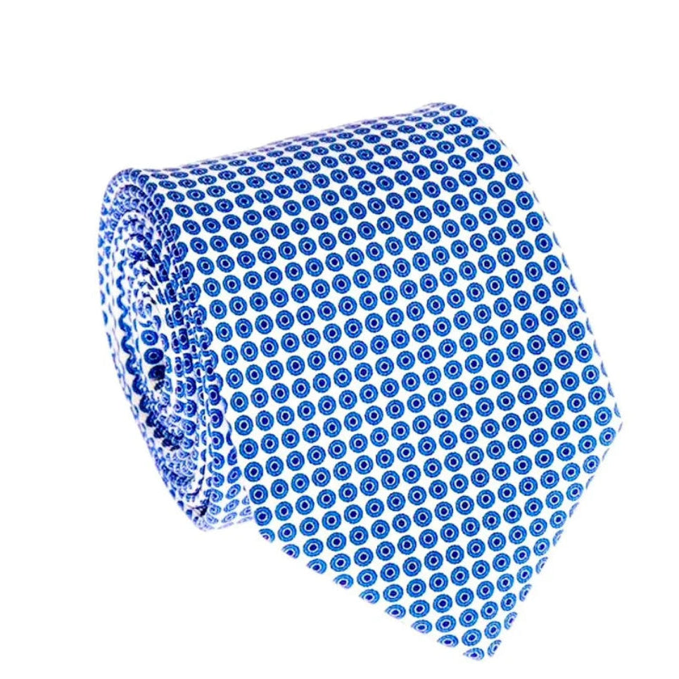 A rolled necktie featuring a repeating pattern of small blue circles on a white background, isolated on a solid white backdrop.