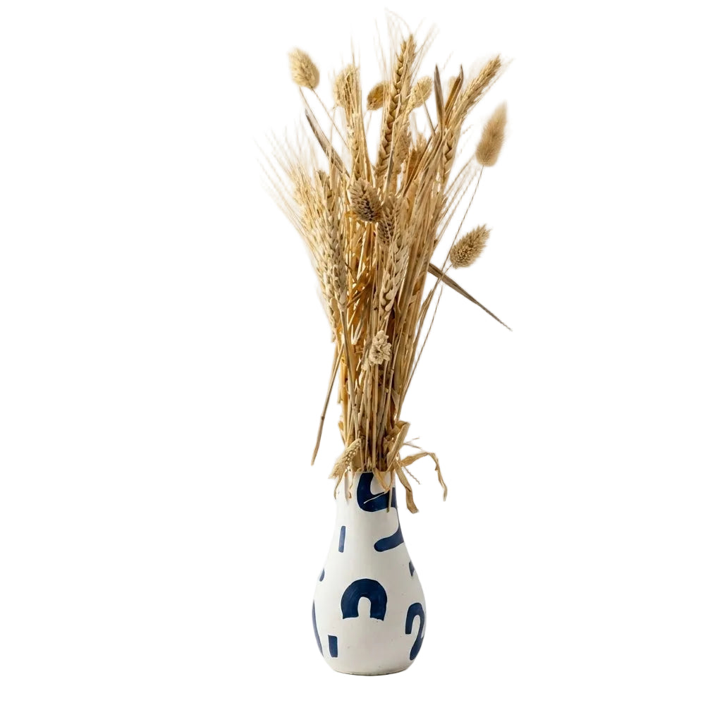 White vase with blue patterns holding dried wheat on a white background